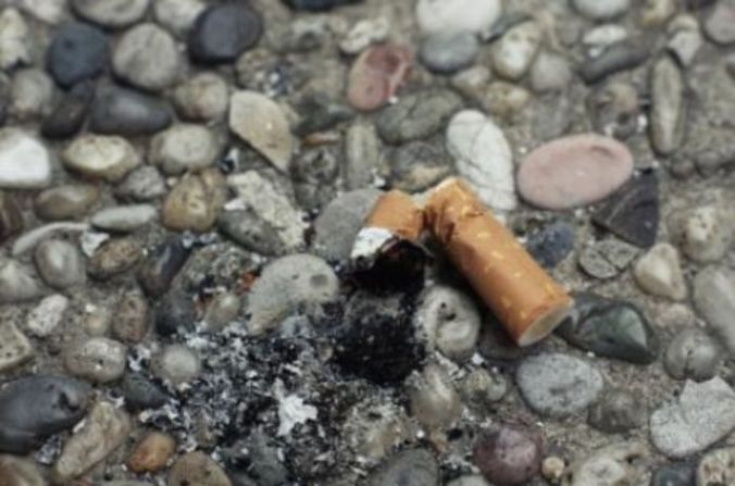 Smashe Marlboro butt on  pebbly ground