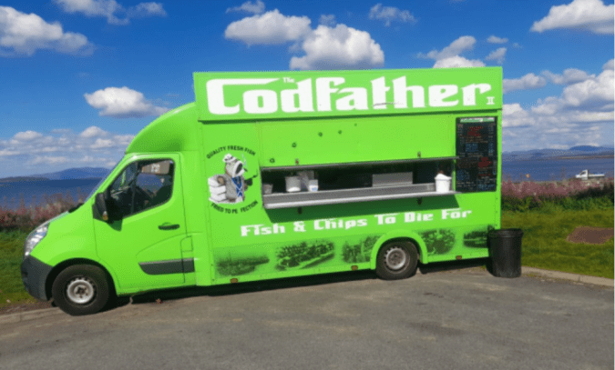 A bright green food truck reading "Codfather's II"