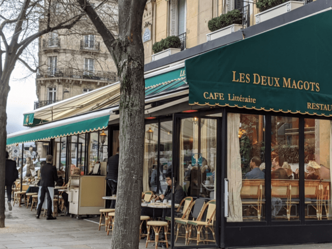 Daytime photo of the outside of the Cafe Les Deus Magots in Paris